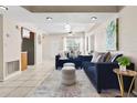 Open-concept living area with tiled flooring, plush seating, and a view of the front entrance at 8184 Rose Ter, Seminole, FL 33777
