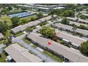 Aerial view of a condo community showcasing well-maintained landscaping and tennis courts at 834 Cambridge Ct, Dunedin, FL 34698