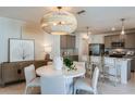 Open-concept dining area complemented by views of the modern kitchen with stainless appliances at 9768 Crescent Moon Dr, Riverview, FL 33578