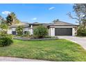 Beautiful home featuring a well-manicured lawn with lush landscaping and a clean, painted exterior at 1004 Hollyberry Ct, Brandon, FL 33511
