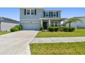 Charming two-story home featuring a manicured lawn, elegant stone accents, and an attached two-car garage at 10749 Tally Fawn Loop, San Antonio, FL 33576
