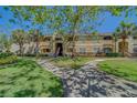 Multi-Gathering building surrounded by lush landscaping, walkways, and shade trees on a sunny day at 1240 S Missouri Ave # 415, Clearwater, FL 33756