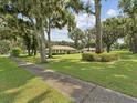 Lush greenery with mature trees surrounds this charming single-story home at 1414 Stephens Oak Ct, Plant City, FL 33567