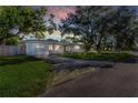 Charming single-story home with a well-maintained lawn, driveway, and mature trees creating a picturesque setting at 1432 S Keene Rd, Clearwater, FL 33756