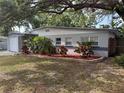 Charming single story home with attached garage, and tropical landscaping at 1542 Sherwood St, Clearwater, FL 33755