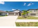 Traditional single-Gathering home boasting a manicured lawn and attached three-car garage at 1873 Colding Dr, Ruskin, FL 33570