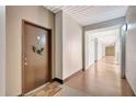 Well-lit hallway with a colorful welcome mat and a door adorned with a wreath, leading to a unit at 2411 W Horatio St # 526, Tampa, FL 33609
