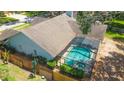 Aerial view of the home's screened-in pool and spa area surrounded by a wood fence at 2505 Buckhorn Run Dr, Valrico, FL 33596