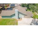 Aerial view of the home showcasing its architectural roof, and concrete driveway at 2505 Buckhorn Run Dr, Valrico, FL 33596