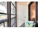 Screened in balcony with chair and palm print pillow, and view of the outside at 2593 Countryside Blvd # 7204, Clearwater, FL 33761