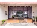 Building entrance featuring large glass doors and covered awning, tiled entry and potted plants at 2593 Countryside Blvd # 7204, Clearwater, FL 33761