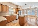 Bright kitchen with wood cabinets, granite countertops, stainless steel appliances, and an island at 2704 Chambray Ln, Tampa, FL 33611