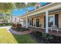 Charming home with brick facade, covered front porch and front yard landscaping at 2718 W Leila Ave, Tampa, FL 33611