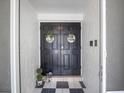 This home features a double-door entry with decor at 2720 Wiltshire Ave, Palm Harbor, FL 34685