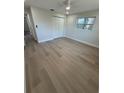 Bright bedroom featuring neutral walls, a closet, plank flooring, and a window letting in natural light at 29813 69Th N St, Clearwater, FL 33761