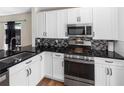 Contemporary kitchen with sleek stainless steel appliances, modern cabinets, and elegant countertops at 302 Summer Sails Dr, Valrico, FL 33594