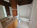 Bathroom featuring a vanity with sink, toilet, and tiled bathtub/shower combination at 3109 Chessington Dr, Land O Lakes, FL 34638