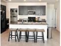 Kitchen featuring an island with seating, stainless steel appliances, and granite countertops at 32699 Dashel Palm Ln, Wesley Chapel, FL 33543