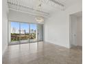 Spacious living room featuring neutral colors, modern lighting, and a balcony at 332 Cocoanut Ave # 505, Sarasota, FL 34236