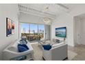 Bright living room with city views, balcony, modern lighting, and neutral tones for a serene atmosphere at 332 Cocoanut Ave # 505, Sarasota, FL 34236