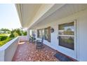 Inviting front porch with mosaic tile, rocking chairs, and a charming front door with sidelights at 3928 90Th N Ter, Pinellas Park, FL 33782