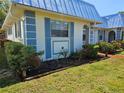 Side view of a well-maintained home with blue accents and tidy landscaping at 4206 Tamargo Dr # 4206, New Port Richey, FL 34652