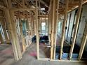 Framed living room area with visible stud framing and windows and door openings to give the area a spacious feel at 4613 Queensboro S Ave, St Petersburg, FL 33711