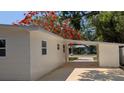 Exterior view of the home featuring clean lines, white siding, windows, and a convenient carport at 4735 W Wisconsin Ave, Tampa, FL 33616