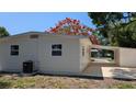 Exterior view of home featuring clean lines, white siding, and a convenient carport at 4735 W Wisconsin Ave, Tampa, FL 33616