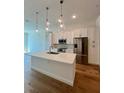 Stylish kitchen featuring white cabinets, stainless steel appliances, and a quartz countertop island at 600 3Rd S Ave # 503, St Petersburg, FL 33701
