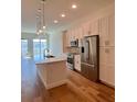Open kitchen with modern appliances, a central island, and balcony access at 600 3Rd S Ave # 503, St Petersburg, FL 33701