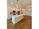 Contemporary kitchen with stainless steel appliances, a quartz countertop island, and hardwood floors at 600 3Rd S Ave # 503, St Petersburg, FL 33701