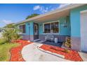 Charming home featuring a cozy front porch, manicured landscaping, and welcoming curb appeal at 6219 57Th N Ave, St Petersburg, FL 33709