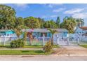 Charming home with a white picket fence, lush landscaping, and a well-maintained lawn creating curb appeal at 6219 57Th N Ave, St Petersburg, FL 33709