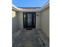 Elegant front door with decorative glass panels and a welcoming entrance at 6241 Westport Dr, Port Richey, FL 34668