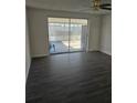 Bright living room with new flooring and sliding glass doors to outside screened patio at 6241 Westport Dr, Port Richey, FL 34668