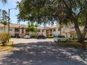 Well-maintained exterior of this two-story townhome with ample parking and mature trees at 7828 Hardwick # 923, New Port Richey, FL 34655