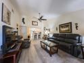 Open living space features vaulted ceiling, updated flooring, and seamless transition to the kitchen at 7828 Hardwick # 923, New Port Richey, FL 34655