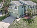 Aerial view of a charming home with a well-manicured lawn and an attached two-car garage at 11102 Avery Oaks Dr, Tampa, FL 33625