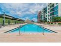 Inviting swimming pool with lounge chairs surrounded by condo complex on a sunny day at 1120 E Kennedy Blvd # 1208, Tampa, FL 33602