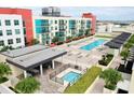 A complex featuring a shared pool, hot tub, sundeck and outdoor dining areas in a modern building at 1120 E Kennedy Blvd # 1208, Tampa, FL 33602