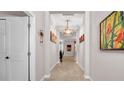 Inviting hallway features tiled floor, neutral paint, decorative accents, and recessed lighting at 11720 Navajo Sandstone St, Riverview, FL 33579
