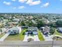 Expansive aerial view showcases the home's location in a quiet neighborhood with lush green landscaping at 11780 Linden Dr, Spring Hill, FL 34608