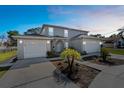 Charming two-story home with attached two-car garage and well-maintained landscaping under a beautiful sky at 11780 Linden Dr, Spring Hill, FL 34608