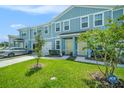 Attractive townhome exterior with a well-kept lawn and a inviting yellow front door at 12264 Grizzly Ln, New Port Richey, FL 34654