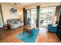 Inviting living room with a comfortable gray sofa, leading to a screened patio with outdoor seating at 1257 Lyndhurst Greens Dr, Sun City Center, FL 33573