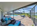 Screened in patio with comfortable seating overlooking a pool with lake views at 1604 Storington Ave, Brandon, FL 33511