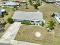 View of home with an attached garage and surrounding neighborhood with manicured lawns at 1809 Haverford Ave, Sun City Center, FL 33573