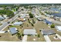 An aerial view shows the single-story home and surrounding neighborhood with mature landscaping at 1809 Haverford Ave, Sun City Center, FL 33573