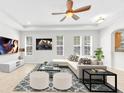 Bright living room features neutral color palette, recessed lighting, and a modern ceiling fan at 215 Oceania Ct, Apollo Beach, FL 33572